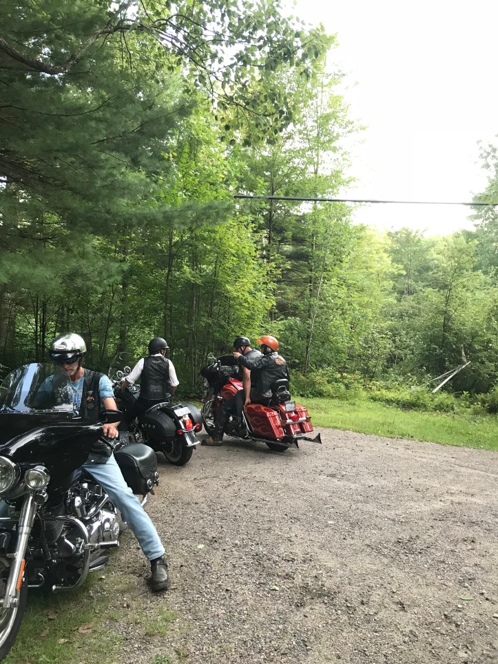 Riders on motorcycles in driveway 